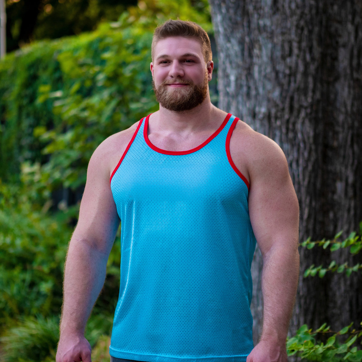 Gay daddy in a blue mesh tank top