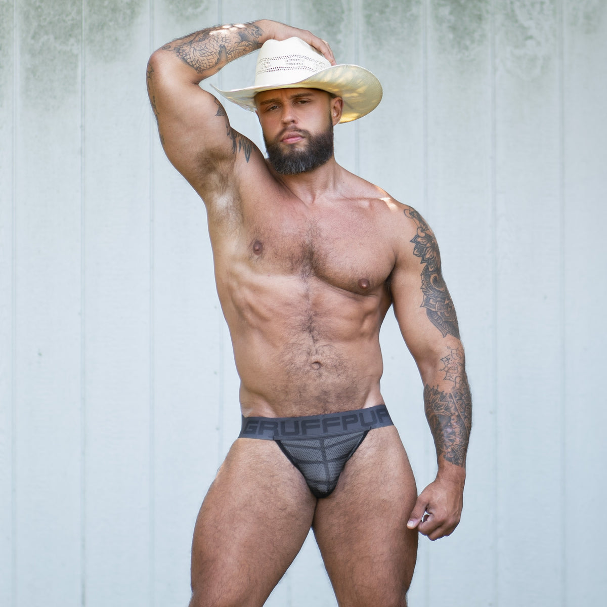 The Gruff Pup Blackout Jockstrap, a dark charcoal gray mesh jockstrap