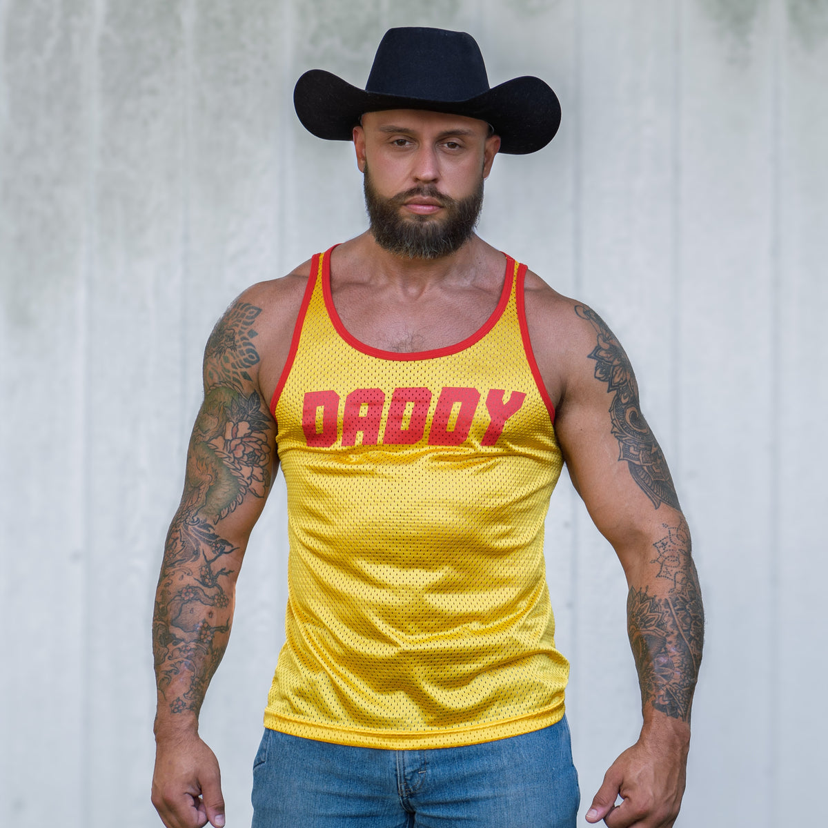 gay gym tank top in yellow with daddy written on the mesh fabric. it is a very sexy mens tank top