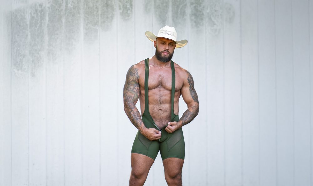 Model Stuart wearing an army green Gruff Pup Easy Release Singlet