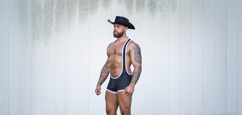 Model Stuart wearing a black and white Gruff Pup Mesh Pro Singlet